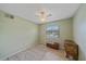 Small bedroom with a neutral rug and a large window with natural light at 2551 W Burr Oak Ct, Sarasota, FL 34232