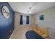 Bright bedroom featuring a blue accent wall and decorative lighting at 2551 W Burr Oak Ct, Sarasota, FL 34232