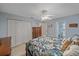 Comfortable bedroom with a ceiling fan, closet and attached bathroom with tile floors at 2551 W Burr Oak Ct, Sarasota, FL 34232