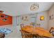 Dining room features an elegant light fixture, colorful artwork, and seating for six around the wooden table at 2551 W Burr Oak Ct, Sarasota, FL 34232