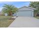 Traditional home featuring an attached garage, mature landscaping, and a well-maintained driveway at 2551 W Burr Oak Ct, Sarasota, FL 34232