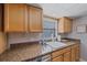 Close-up of the kitchen counter with granite countertops and stainless steel appliances at 2551 W Burr Oak Ct, Sarasota, FL 34232