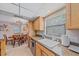 Kitchen featuring granite countertops, stainless steel appliances, tile floors and a view of the dining room at 2551 W Burr Oak Ct, Sarasota, FL 34232