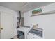 Laundry area with white washer and dryer, shelving and utility connections at 2551 W Burr Oak Ct, Sarasota, FL 34232