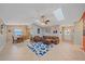 Spacious living room features skylights, tile floors, comfortable seating, and seamless flow to dining at 2551 W Burr Oak Ct, Sarasota, FL 34232