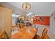 Open concept kitchen and living area, with a dining table in the foreground and colorful art on the wall at 2551 W Burr Oak Ct, Sarasota, FL 34232