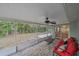 Covered patio with fan and seating with a view of the backyard at 2551 W Burr Oak Ct, Sarasota, FL 34232