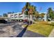 Condominium exterior showing parking, landscaping, flag, and balconies at 3300 S Beneva Rd # 224, Sarasota, FL 34232