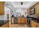 Charming kitchen features wooden cabinetry, stainless appliances, and black countertops at 3300 S Beneva Rd # 224, Sarasota, FL 34232