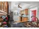 Well-lit kitchen features black countertops, a built-in desk, and wooden cabinets at 3300 S Beneva Rd # 224, Sarasota, FL 34232