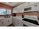 Modern kitchen with white cabinets, countertop, stainless steel sink, and appliances at 1626 Stickney Point Rd # 26-102, Sarasota, FL 34231