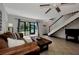 Open concept living room with tile floors, sliding door to back porch, and stairs to the second floor at 1626 Stickney Point Rd # 26-102, Sarasota, FL 34231