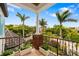 Balcony with wrought iron railing, manicured trees, and view of neighborhood at 1810 Lincoln Dr, Sarasota, FL 34236