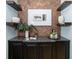 Bar area featuring a countertop, cabinetry, and decorative brick wall at 1810 Lincoln Dr, Sarasota, FL 34236