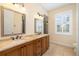Dual sink bathroom with granite countertops and glass enclosed shower at 1810 Lincoln Dr, Sarasota, FL 34236