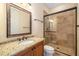 Bathroom featuring a glass-enclosed shower, granite countertop and wood vanity at 1810 Lincoln Dr, Sarasota, FL 34236