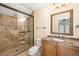 Bathroom featuring a glass-enclosed shower, granite countertop and vanity at 1810 Lincoln Dr, Sarasota, FL 34236