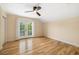 Bedroom with hardwood floors and sliding doors to the balcony at 1810 Lincoln Dr, Sarasota, FL 34236
