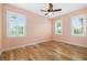 Bedroom featuring three windows with blinds and light pink walls at 1810 Lincoln Dr, Sarasota, FL 34236