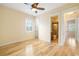 Bright bedroom with hardwood floors, ceiling fan, and bathroom access at 1810 Lincoln Dr, Sarasota, FL 34236