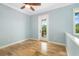 Bright bedroom with wood floors and French door leading to balcony at 1810 Lincoln Dr, Sarasota, FL 34236
