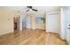 Bedroom with hardwood floors, a ceiling fan, and bathroom access at 1810 Lincoln Dr, Sarasota, FL 34236