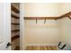 Walk in closet with wooden shelves and hardwood floors at 1810 Lincoln Dr, Sarasota, FL 34236