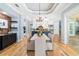 Dining room area with a chandelier, hardwood floors, and view of the kitchen at 1810 Lincoln Dr, Sarasota, FL 34236