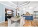 Dining room with elegant chandelier, hardwood floors, and view into the kitchen at 1810 Lincoln Dr, Sarasota, FL 34236