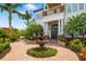 Impressive home with manicured landscaping, a tiered fountain, and a welcoming brick pathway at 1810 Lincoln Dr, Sarasota, FL 34236