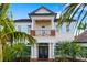 Elegant home with a covered balcony, beautiful landscaping, and striking architectural details at 1810 Lincoln Dr, Sarasota, FL 34236