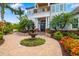 Beautiful home with a tiered fountain, manicured landscaping, and a welcoming brick path at 1810 Lincoln Dr, Sarasota, FL 34236