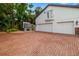 Spacious three-car garage with brick driveway, side-mounted generator and second story balcony at 1810 Lincoln Dr, Sarasota, FL 34236