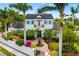 Beautiful two-story home with mature trees, lush landscaping, and a charming fountain entrance at 1810 Lincoln Dr, Sarasota, FL 34236