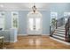 Elegant foyer showcasing a grand staircase, beautiful wood floors, and decorative glass doors at 1810 Lincoln Dr, Sarasota, FL 34236