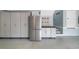 Well-organized garage features built-in cabinets and stainless steel refrigerator at 1810 Lincoln Dr, Sarasota, FL 34236