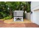Close up of the home's Kohler backup generator with decorative rock and brick ground covering at 1810 Lincoln Dr, Sarasota, FL 34236