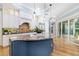 Beautiful kitchen featuring island sink, stainless steel appliances, hardwood floors, and plenty of natural light at 1810 Lincoln Dr, Sarasota, FL 34236