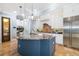 Bright, open kitchen featuring blue island, granite countertops, and modern appliances at 1810 Lincoln Dr, Sarasota, FL 34236