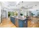 Open-concept kitchen featuring a large island, stainless steel appliances, and seamless indoor-outdoor flow at 1810 Lincoln Dr, Sarasota, FL 34236