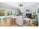 Bright living room with fireplace, ceiling fan, and sliding glass doors to the backyard pool at 1810 Lincoln Dr, Sarasota, FL 34236