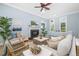 Living room with fireplace, large windows, ceiling fan, and comfortable seating at 1810 Lincoln Dr, Sarasota, FL 34236