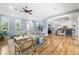 Open-concept living area showcasing hardwood floors and a seamless flow to the kitchen and staircase at 1810 Lincoln Dr, Sarasota, FL 34236