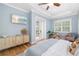Comfortable primary bedroom features a beach view on the television, a tray ceiling, and light walls at 1810 Lincoln Dr, Sarasota, FL 34236