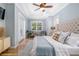 Main bedroom featuring a tray ceiling, hardwood floors, and white plantation shutters on the windows at 1810 Lincoln Dr, Sarasota, FL 34236
