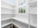 Well-organized pantry featuring ample shelving and natural light from the window at 1810 Lincoln Dr, Sarasota, FL 34236