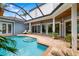 Outdoor pool area featuring a waterfall, patio, and lounge chairs at 1810 Lincoln Dr, Sarasota, FL 34236
