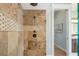 Walk-in shower with rain head, body sprays, and decorative tile border at 1810 Lincoln Dr, Sarasota, FL 34236