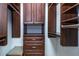 Walk-in closet featuring extensive dark wood cabinetry and drawers for organized storage at 1810 Lincoln Dr, Sarasota, FL 34236