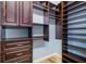 Walk-in closet with dark wood cabinetry and shelving for ample storage at 1810 Lincoln Dr, Sarasota, FL 34236